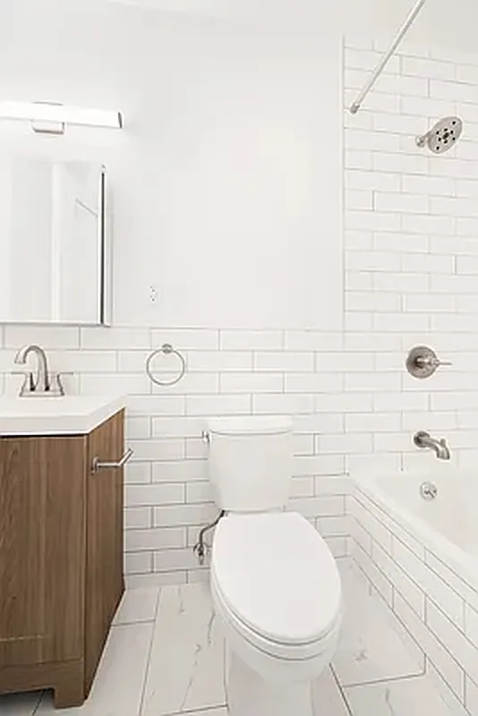82 Clinton Avenue, Unit 4 Brooklyn, NY 11205 - Photo 8 of 11 a bathroom with a sink a toilet and shower