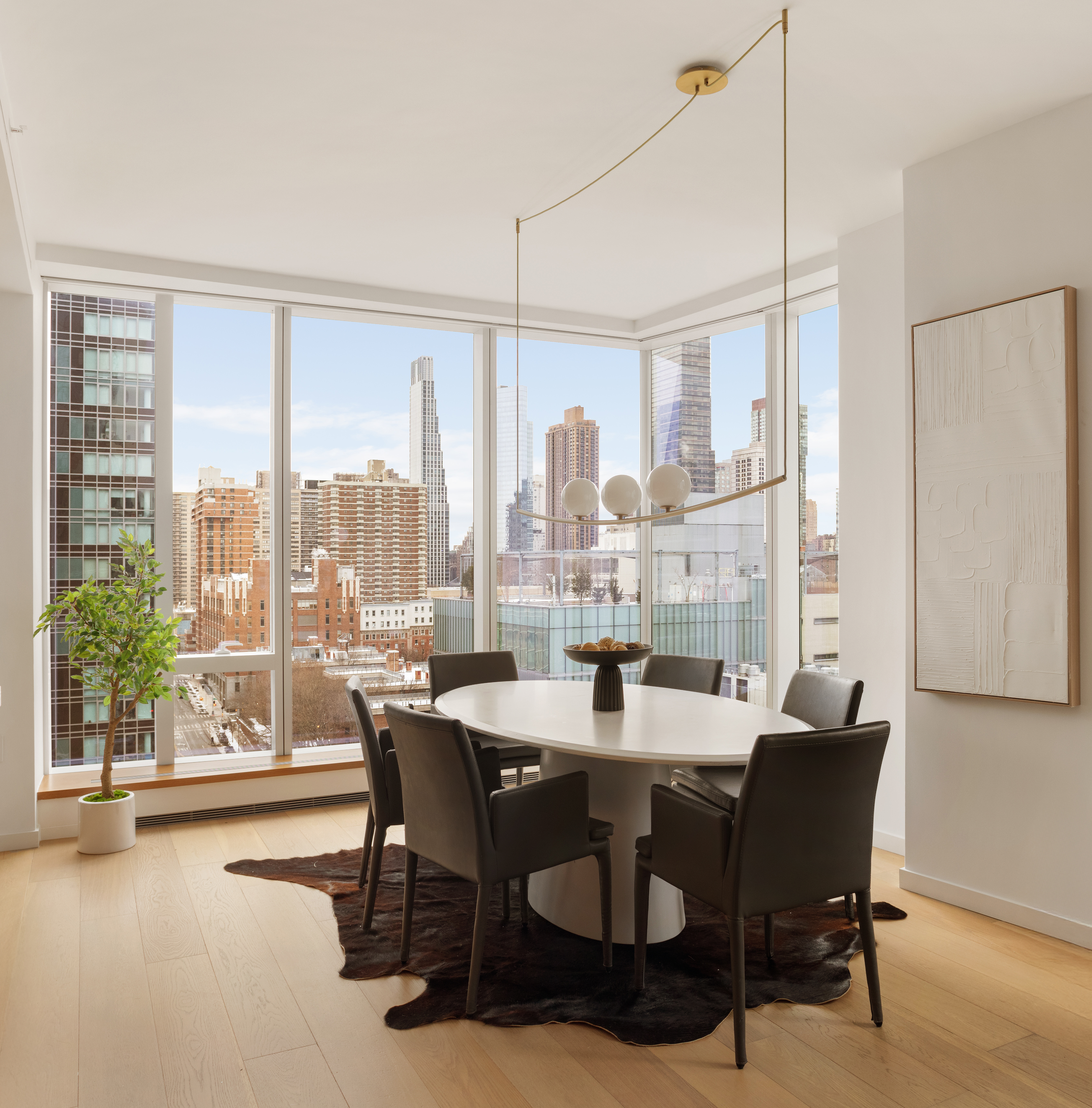 1 West End Avenue, Unit 12D Manhattan, NY 10023 - Photo 5 of 32 a dining room with furniture a chandelier and wooden floor