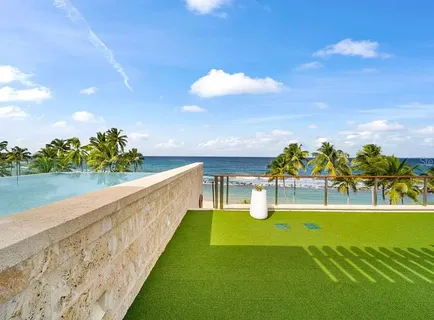 a view of a swimming pool with an outdoor seating and a garden
