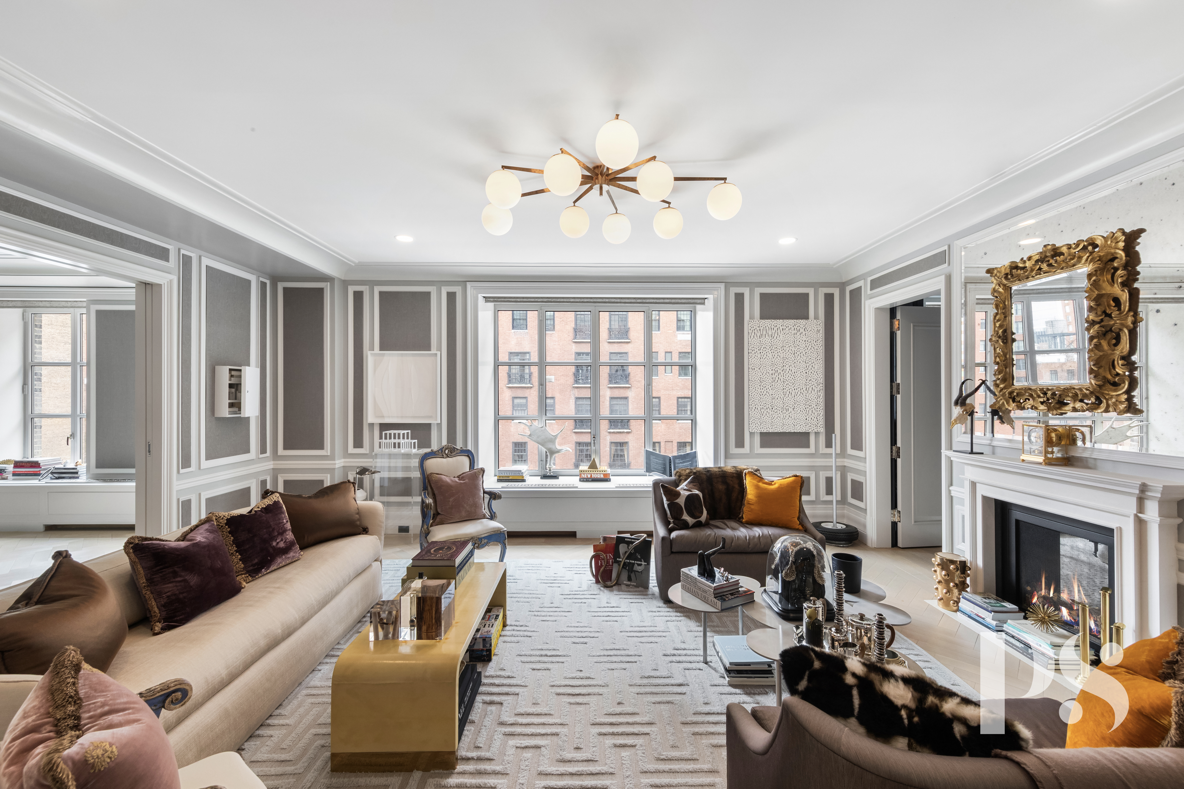135 East 79th Street, Unit 8E Manhattan, NY 10075 - Photo 1 of 26 a living room with furniture fireplace and large windows