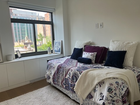 124 East 79th Street, Unit 7D Manhattan, NY 10075 - Photo 24 of 26 a bed sitting in a bedroom next to a window
