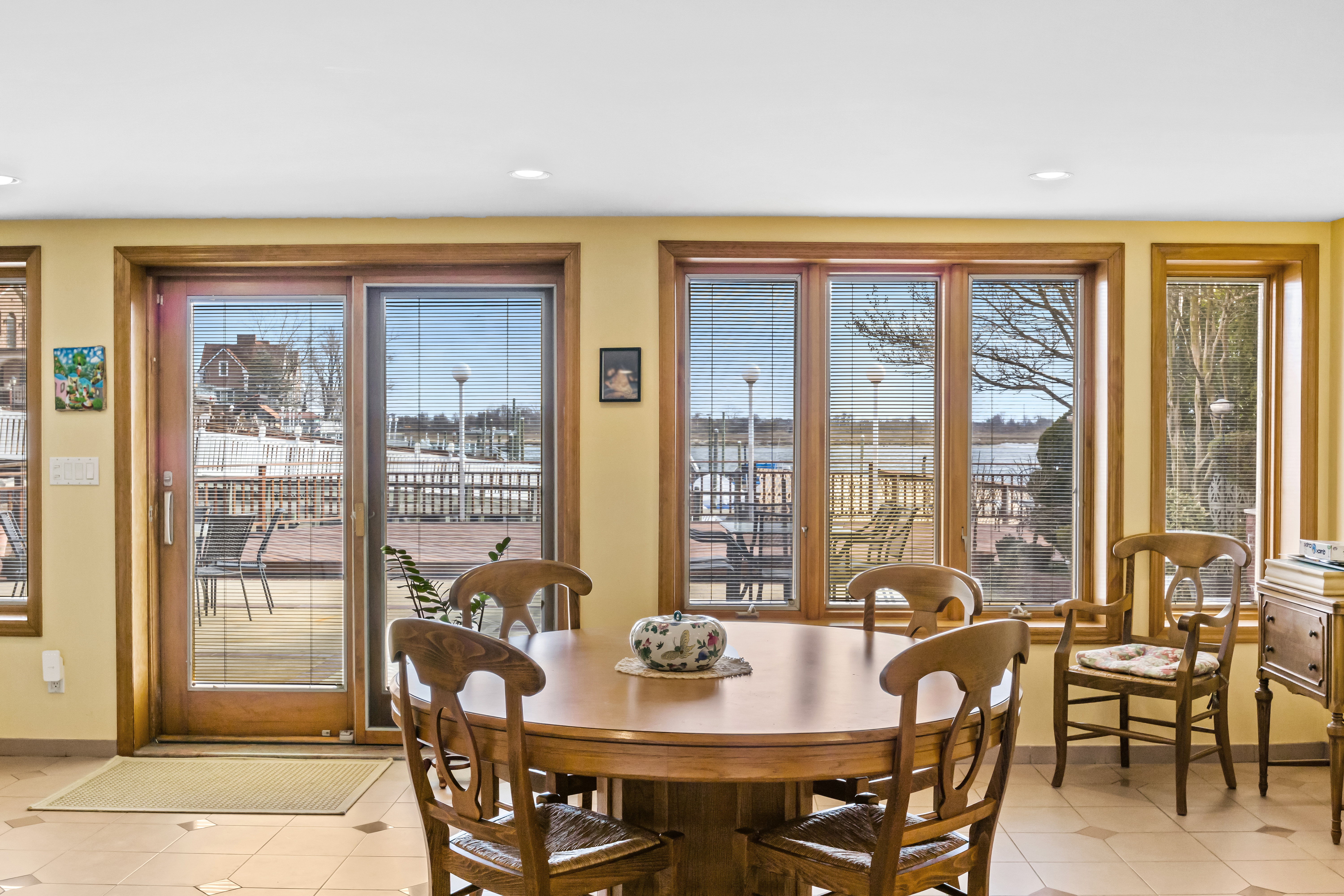 303 Whitman Drive Brooklyn, NY 11234 - Photo 14 of 37 a view of a dining room with furniture large windows and wooden floor