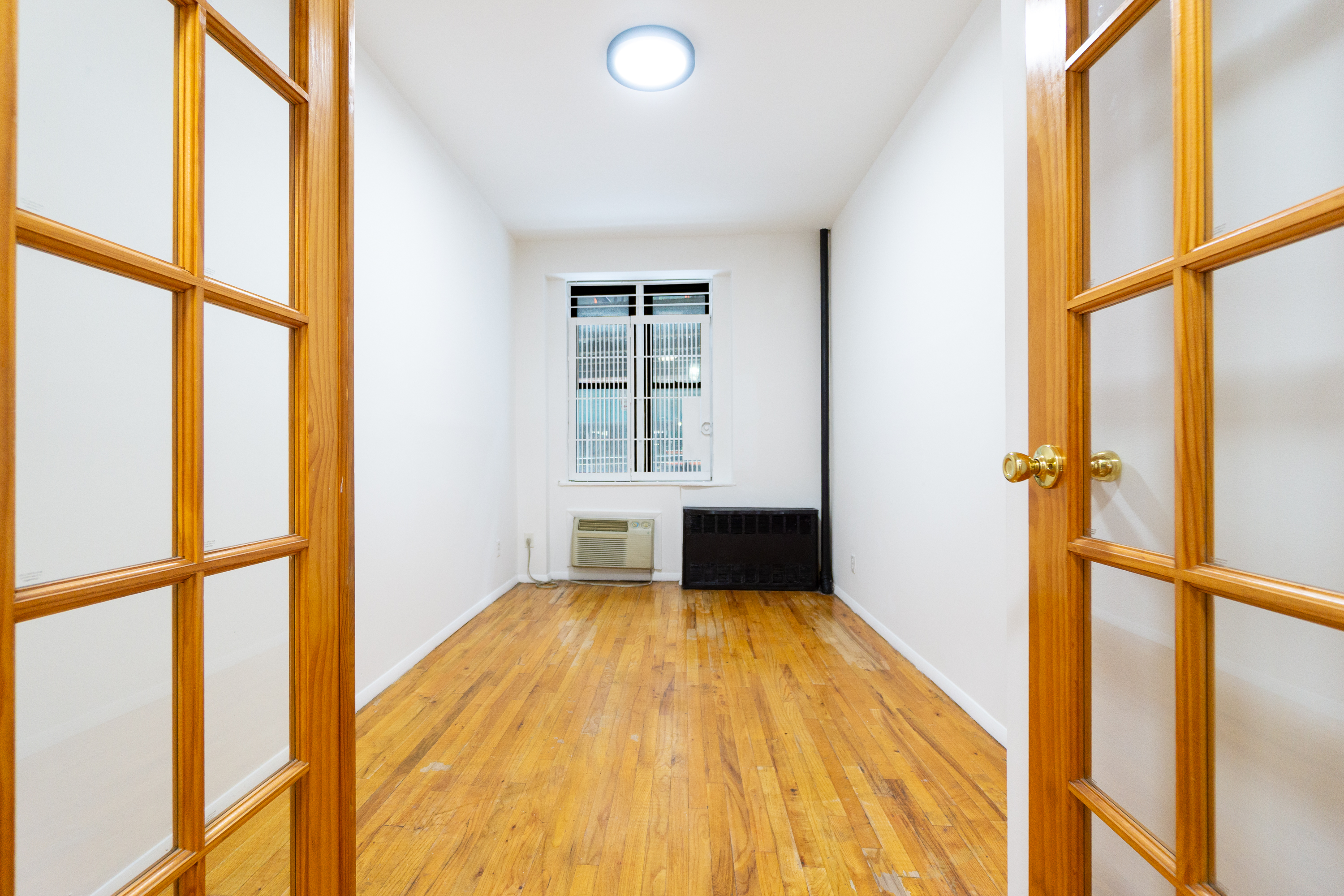 a view of wooden floor in a room with a window