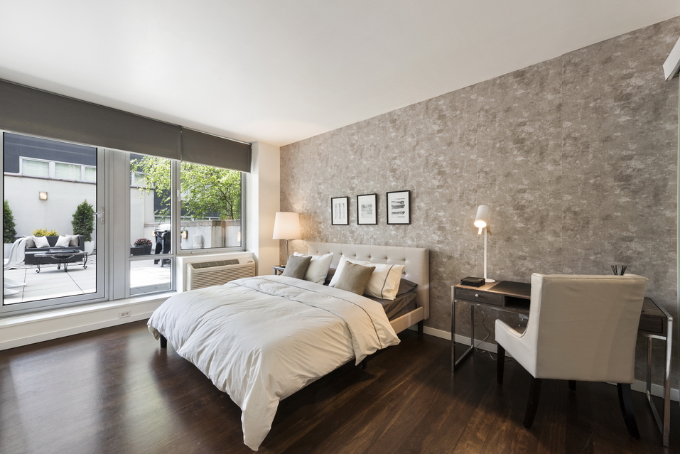 444 West 19th Street, Unit 201 Manhattan, NY 10011 - Photo 6 of 13 a bedroom with a bed and a table