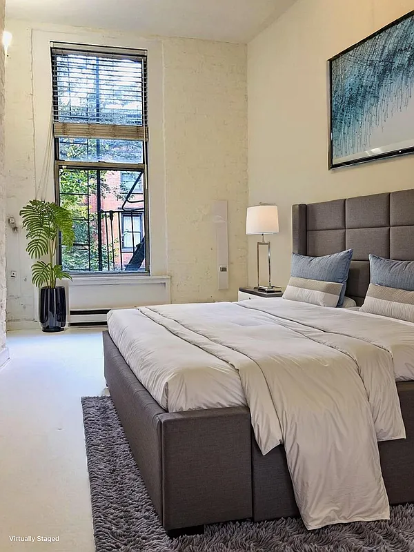 112 West 15th Street, Unit 2 Manhattan, NY 10011 - Photo 3 of 13 a bedroom with a bed flowerpot and window