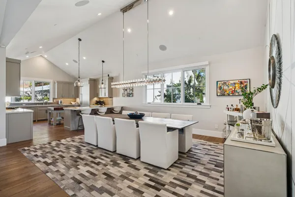 a living room with furniture a flat screen tv and kitchen view