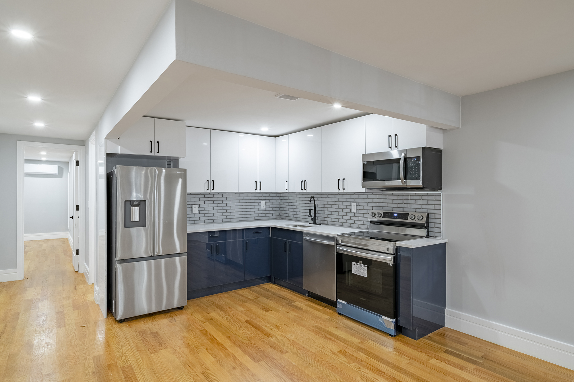 192 Weirfield Street, Unit ONE Brooklyn, NY 11221 - Photo 3 of 8 a kitchen with stainless steel appliances granite countertop a refrigerator a stove top oven a sink and dishwasher