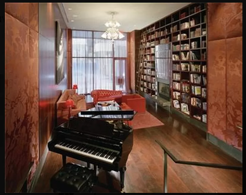 88 Greenwich Street, Unit 821 Manhattan, NY 10006 - Photo 8 of 10 a reading room with furniture and a bookshelf