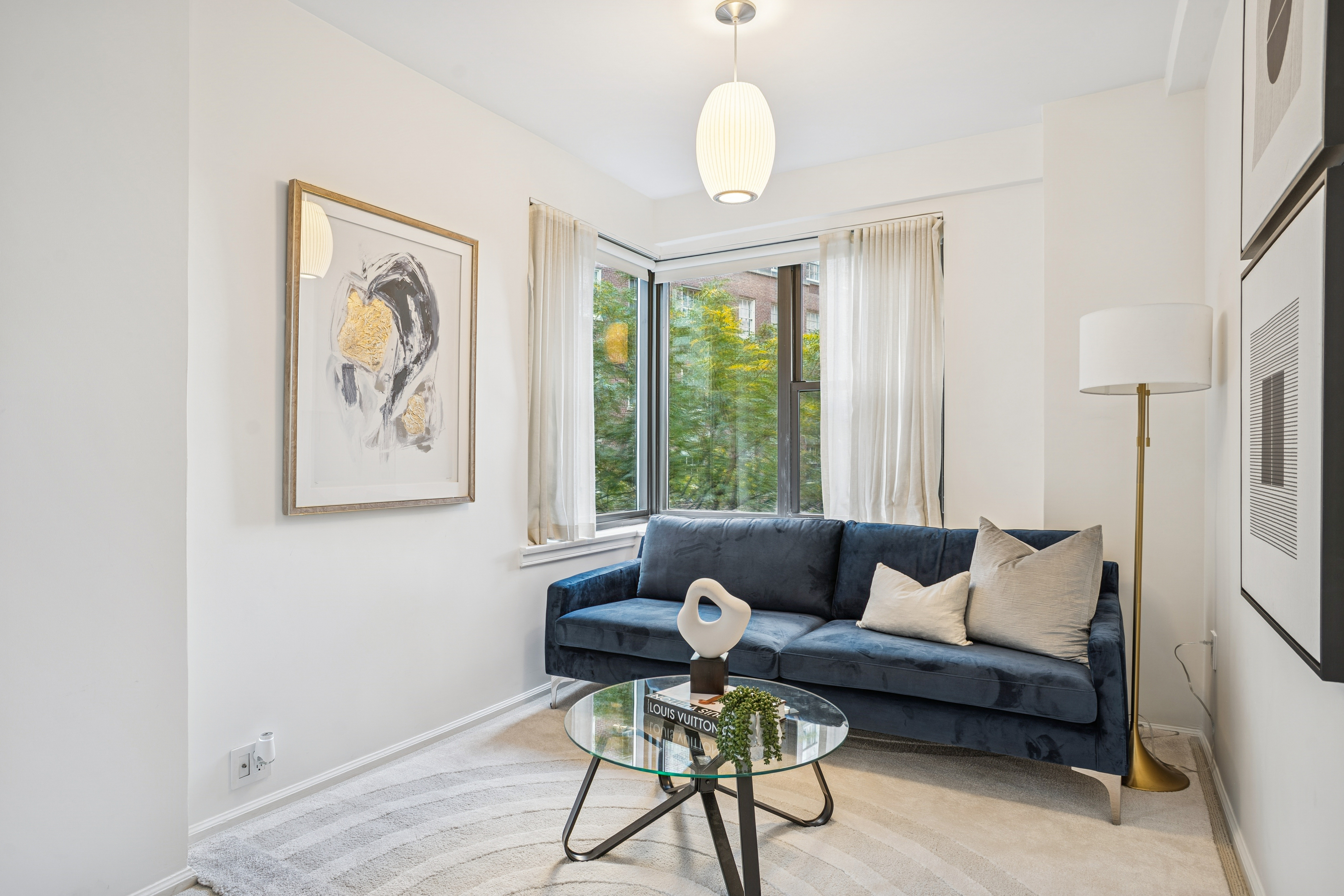 440 East 56th Street, Unit 6FGH Manhattan, NY 10022 - Photo 8 of 18 a living room with furniture and a large window