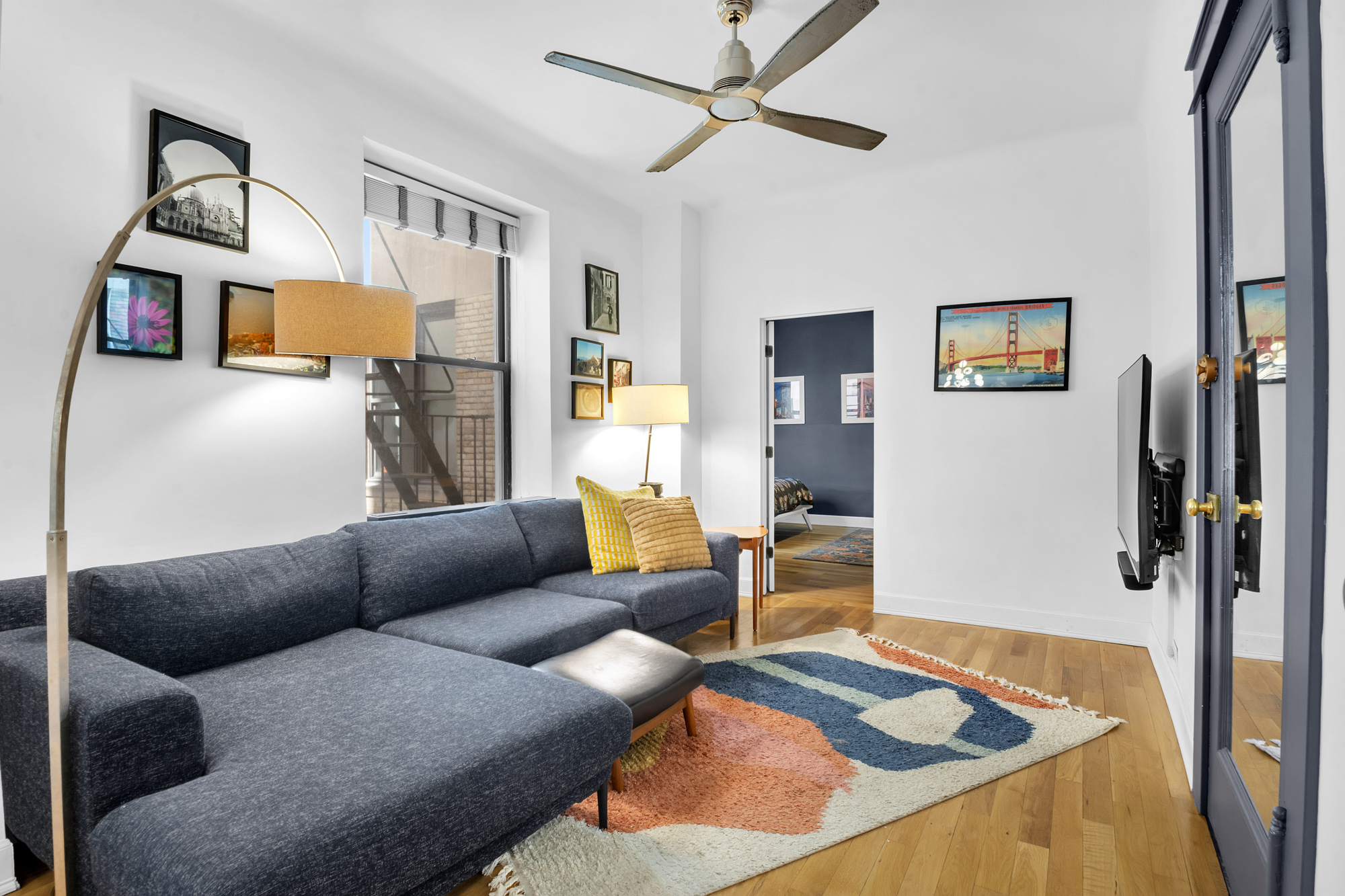 790 Riverside Drive, Unit 2LX Manhattan, NY 10032 - Photo 4 of 10 a living room with furniture and a flat screen tv