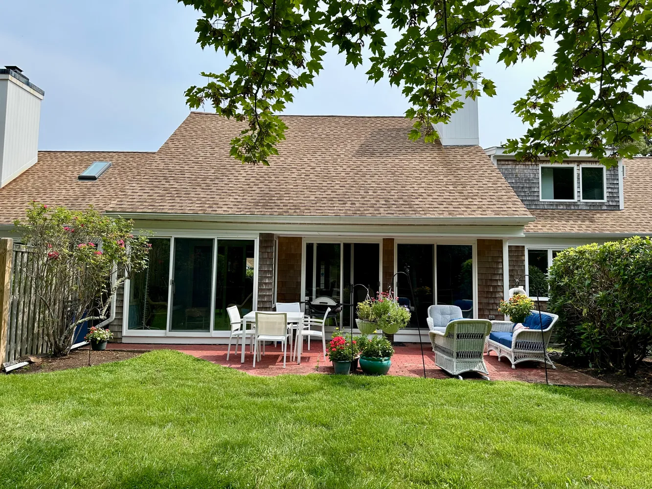 a view of a house with a patio and a garden