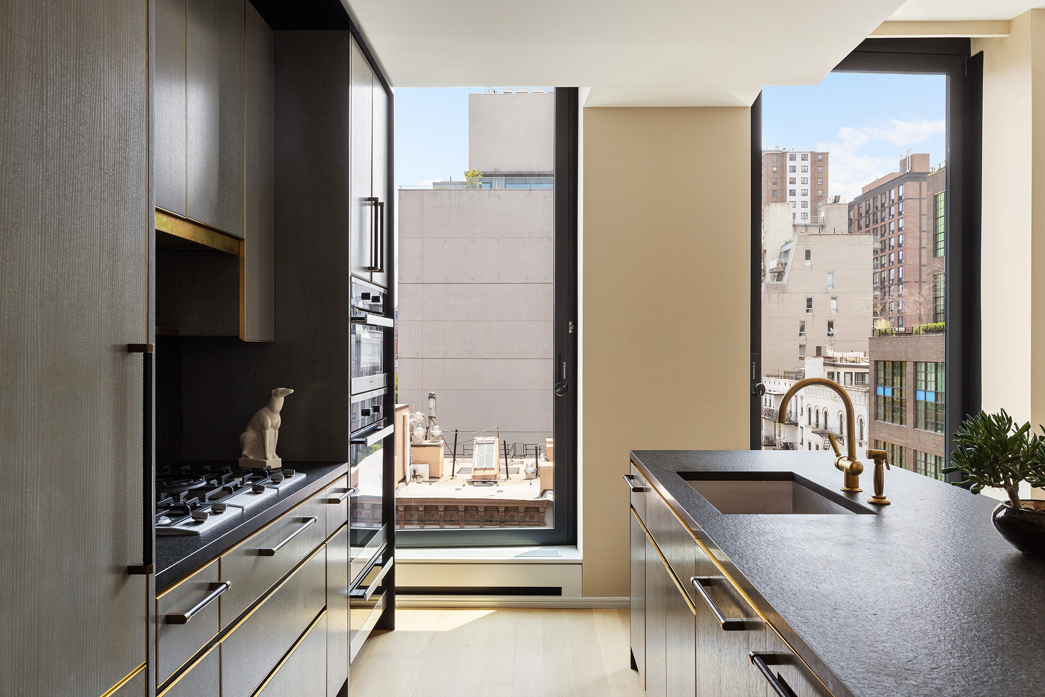 505 West 19th Street, Unit 7B Manhattan, NY 10011 - Photo 6 of 16 a kitchen with a stove a sink and a refrigerator