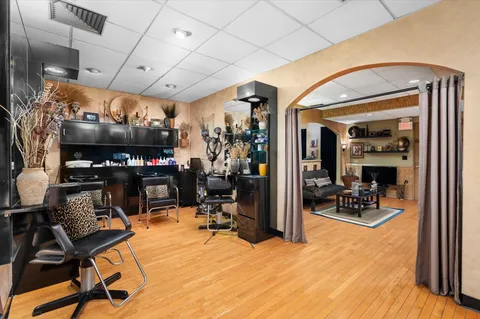 a room with lots of chairs and mirrors