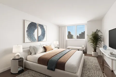 a bedroom with a bed and a flat screen tv