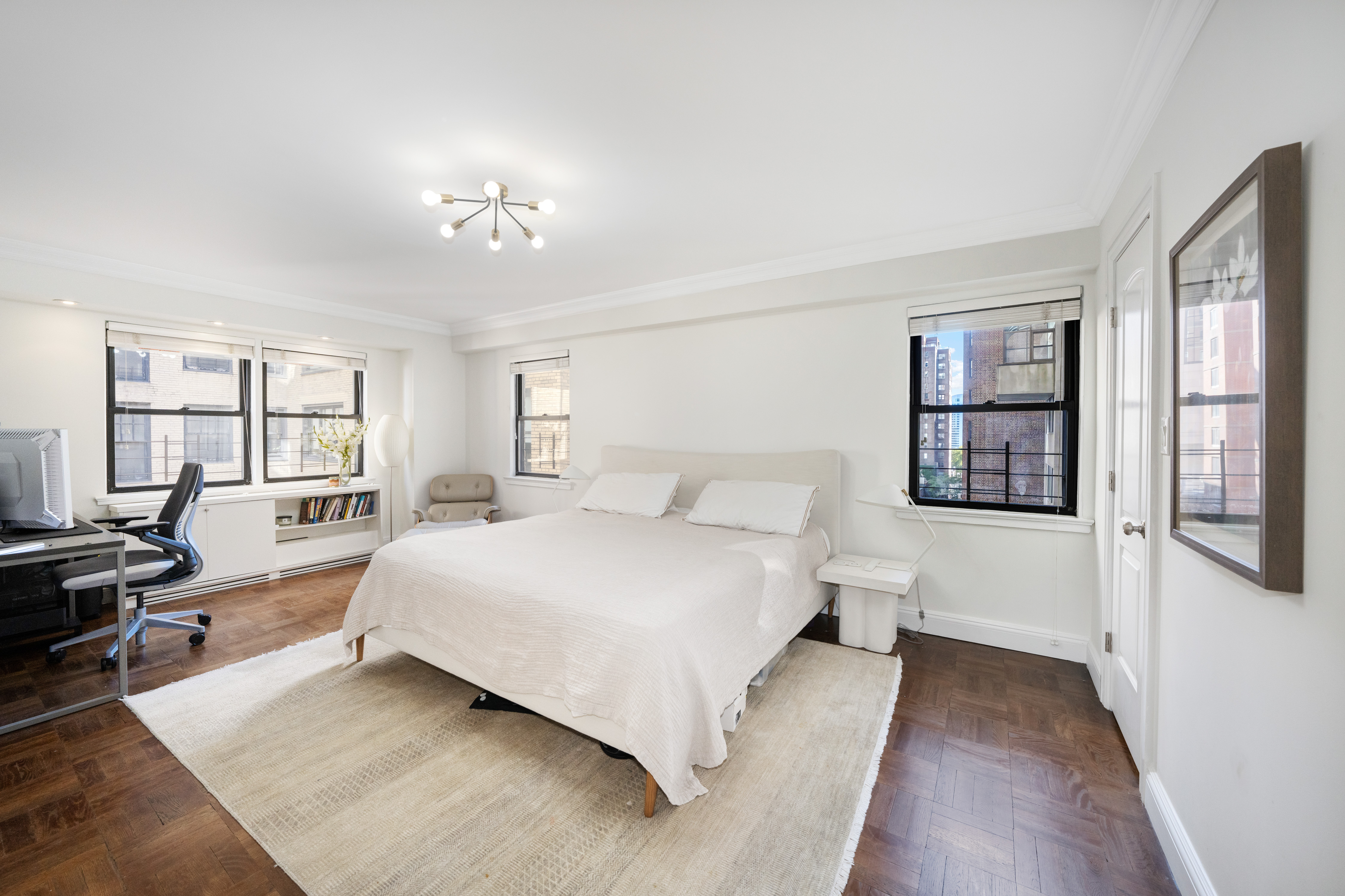 411 East 57th Street, Unit 11AB Manhattan, NY 10022 - Photo 8 of 17 a spacious bedroom with a large bed and a window