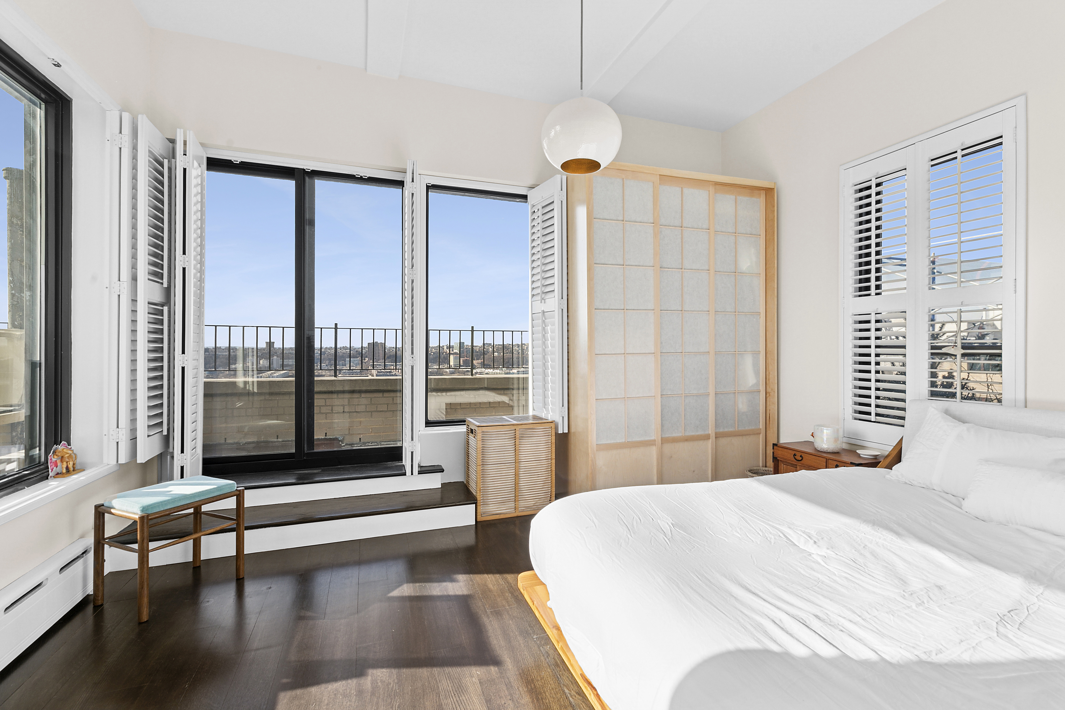 310 West 106th Street, Unit PH17B Manhattan, NY 10025 - Photo 5 of 9 a bedroom with a large window and a bed