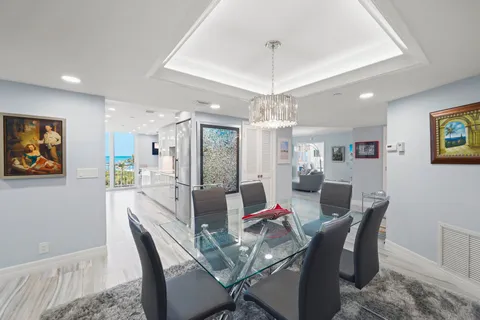 a view of a dining room with furniture wooden floor and a chandelier