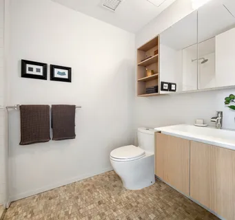 a bathroom with a sink toilet and mirror