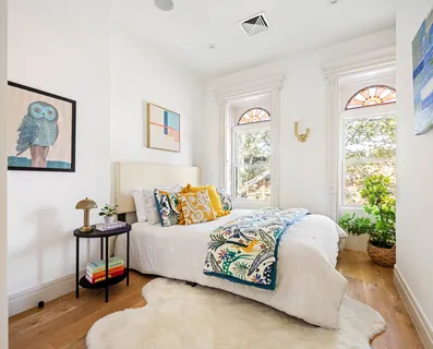 a bedroom with a bed and a window