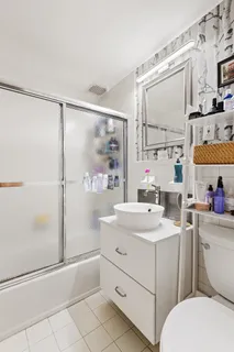 a bathroom with a sink toilet vanity and tub
