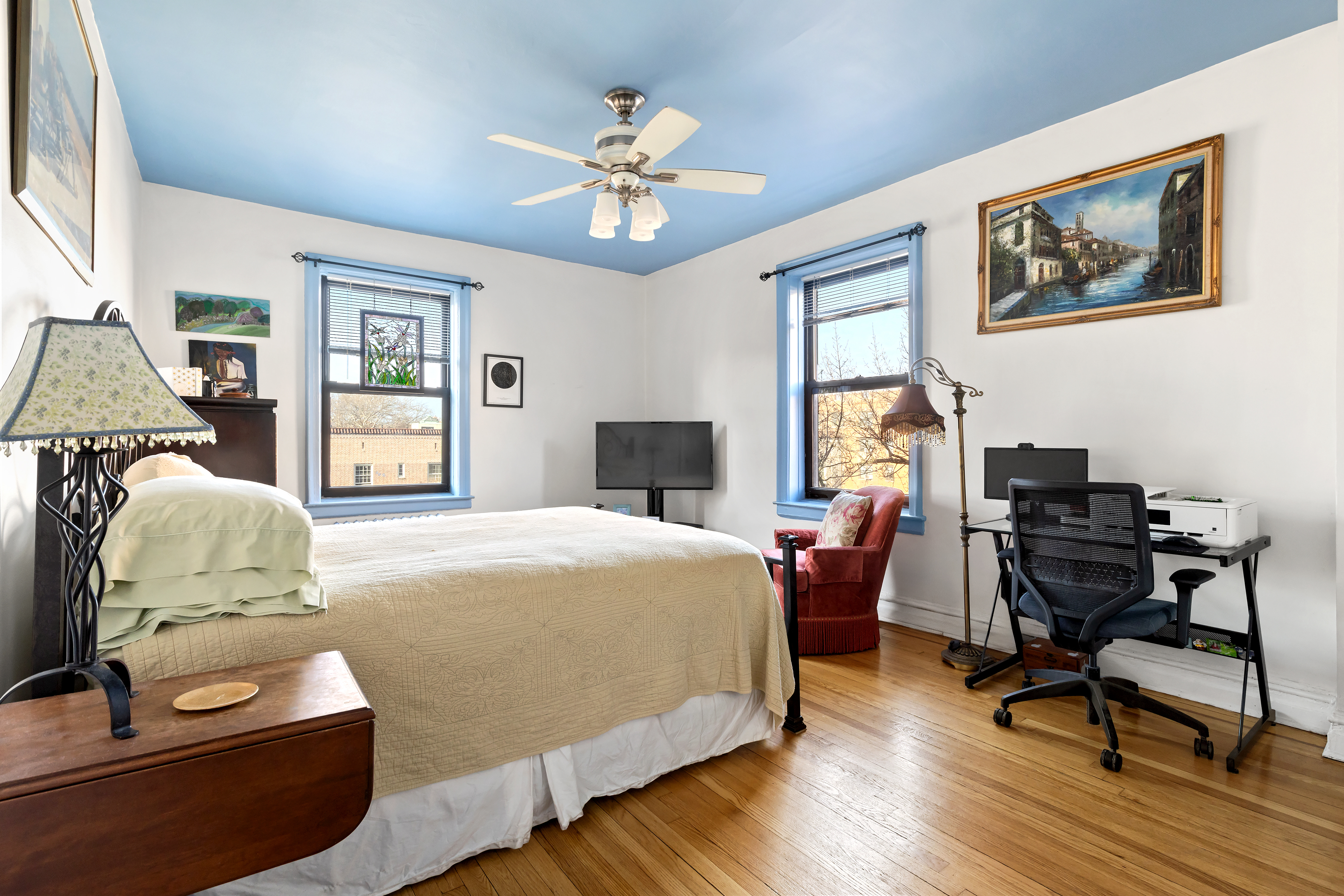 83-10 35th Avenue, Unit 5O Queens, NY 11372 - Photo 3 of 8 a bedroom with a bed and wooden floor