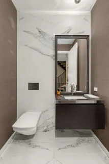 a bathroom with a sink a toilet and mirror
