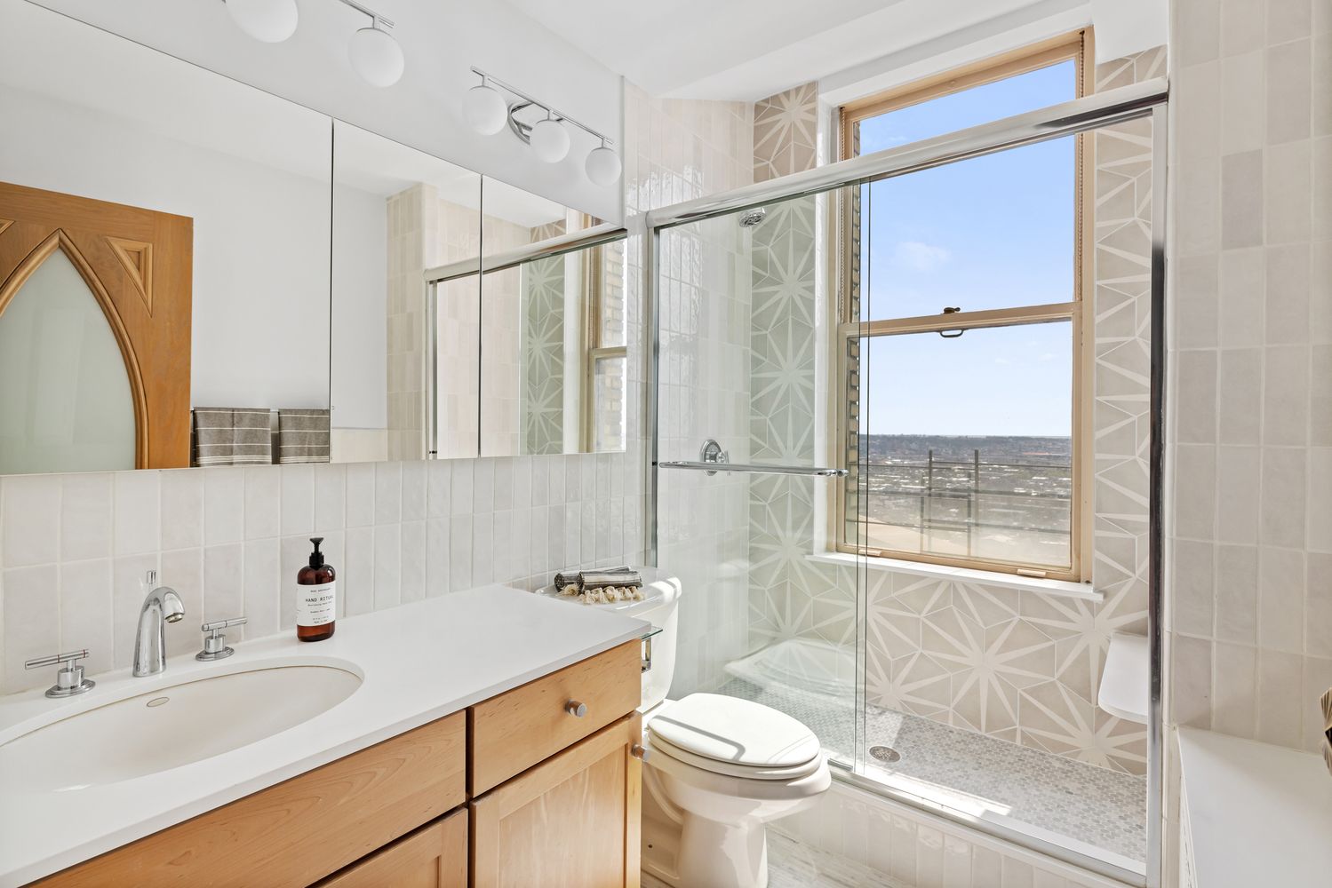 a bathroom with a sink toilet and shower