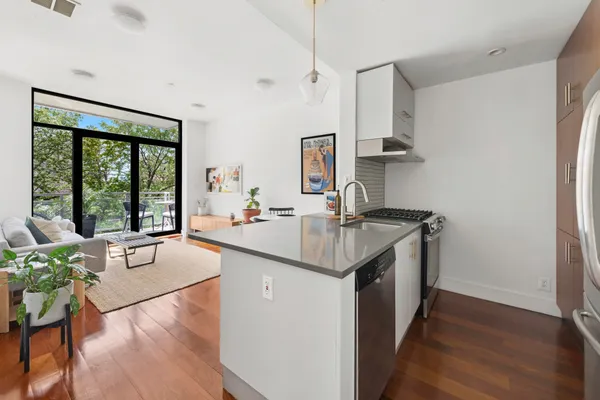 a kitchen with a sink cabinets and wooden floor