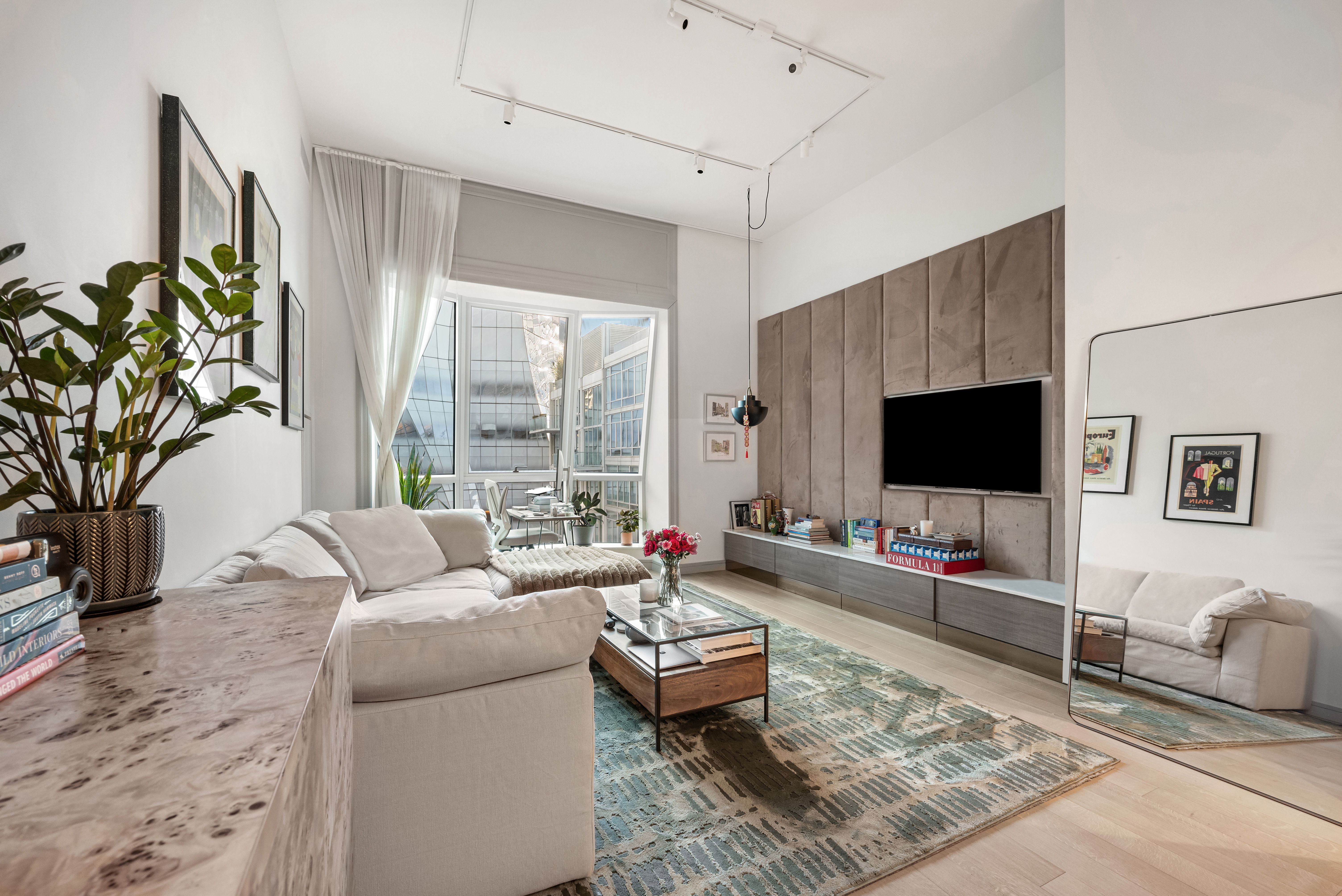 515 West 18th Street, Unit 901 Manhattan, NY 10011 - Photo 2 of 14 a living room with furniture and a flat screen tv