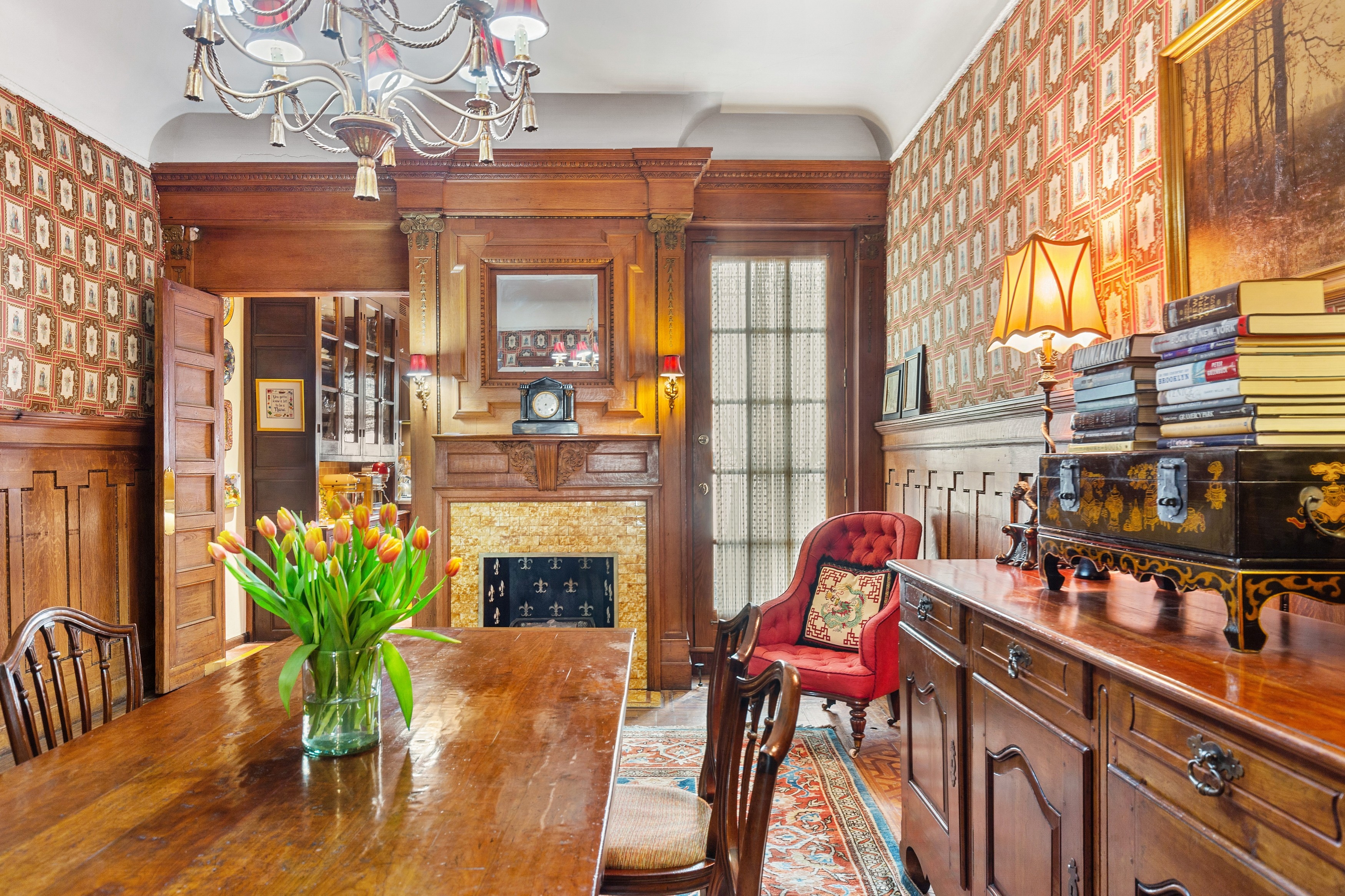 333 West 71st Street Manhattan, NY 10023 - Photo 6 of 29 a dining room with furniture a chandelier and wooden floor