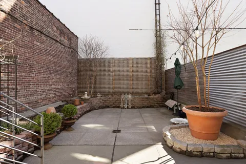 a view of a patio with couches and potted plants