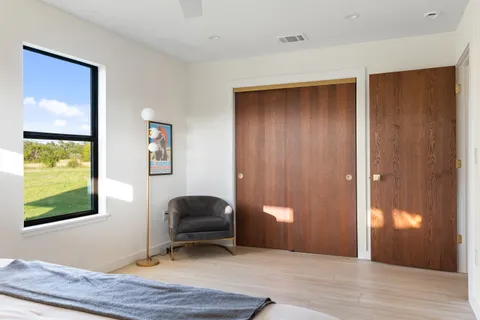 a workspace room with wooden floor and windows