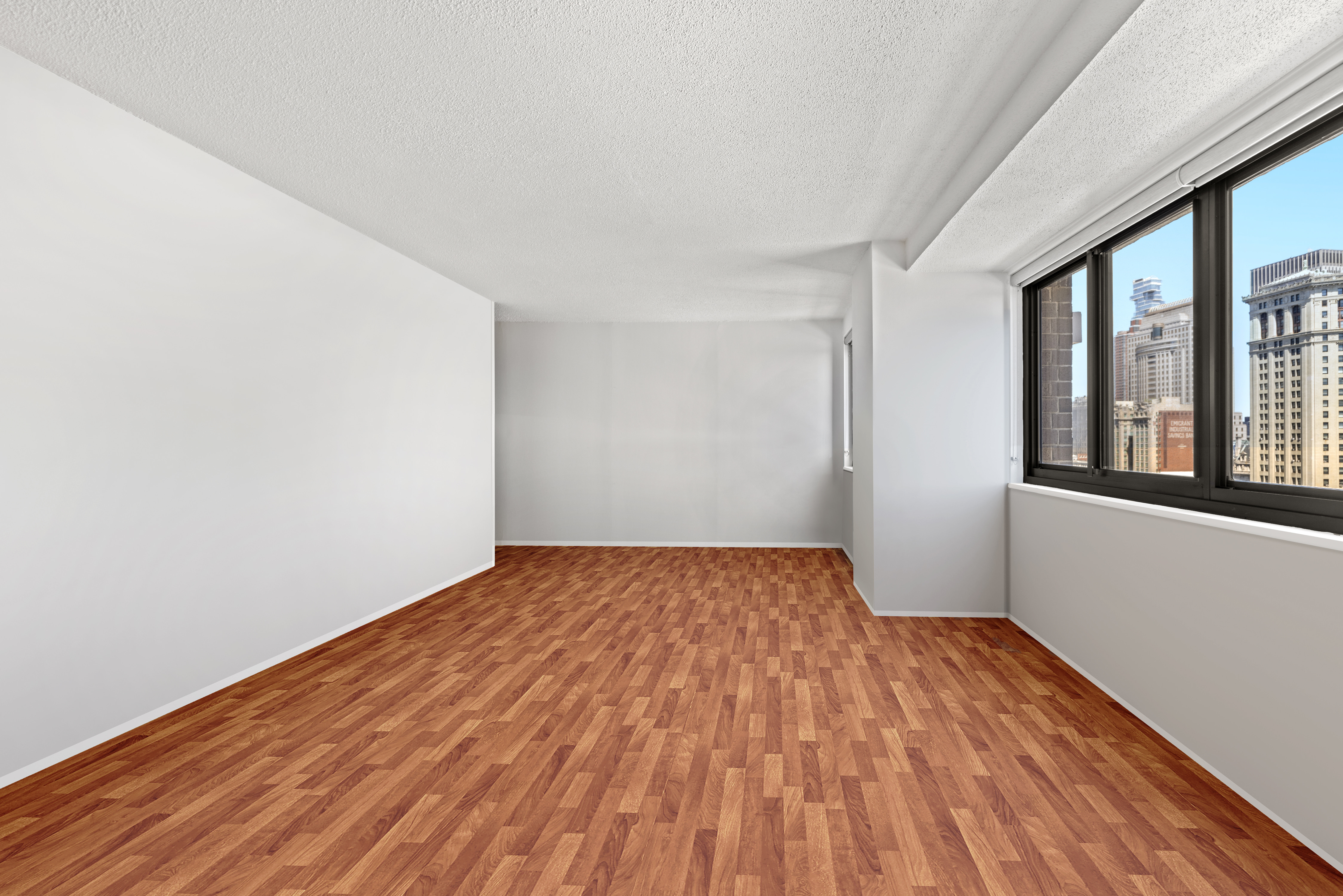 90 Gold Street, Unit 21G Manhattan, NY 10038 - Photo 7 of 9 a view of empty room with wooden floor and fan