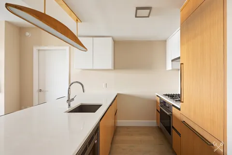 a kitchen that has a sink and a stove