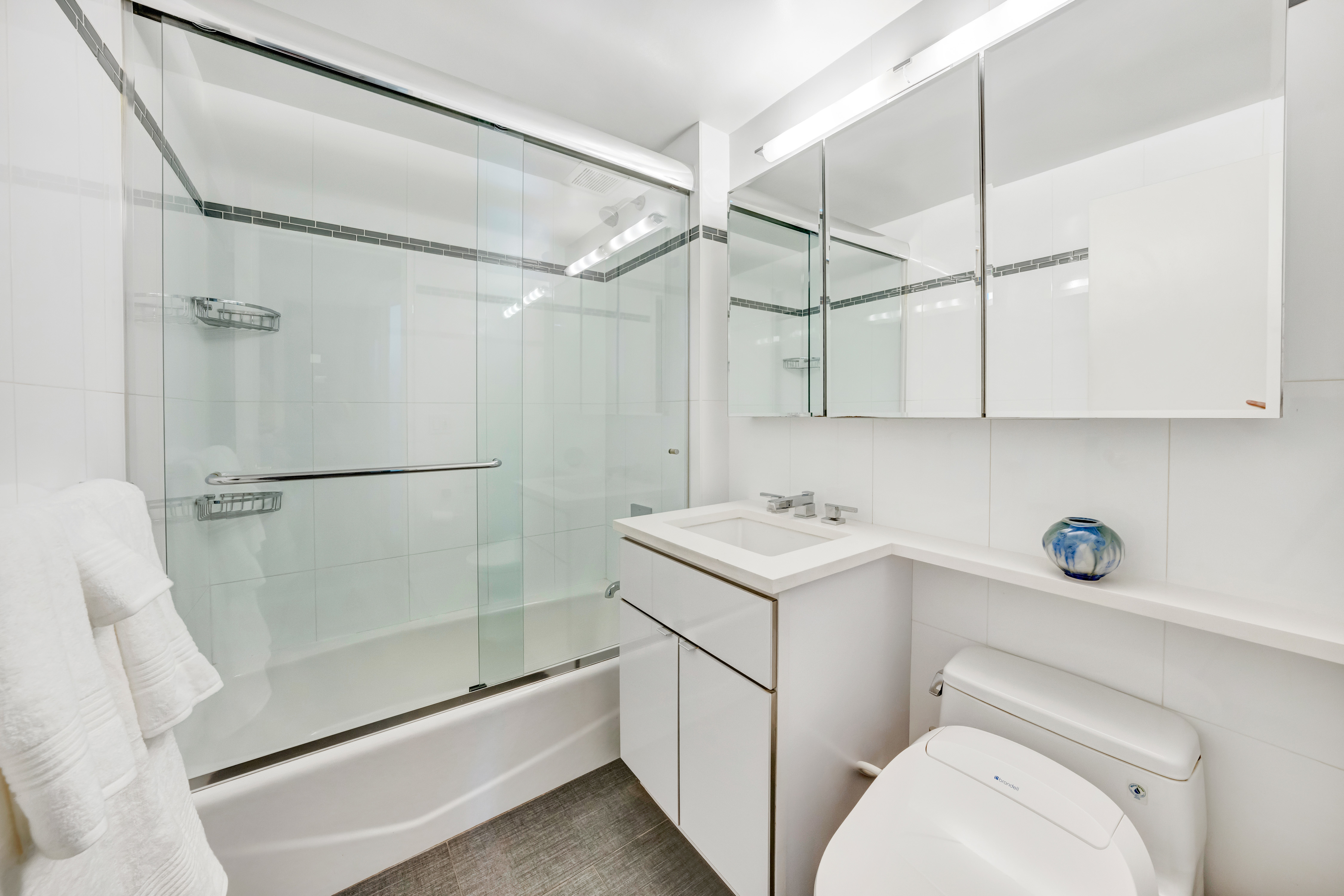 35 Sutton Place, Unit 7E Manhattan, NY 10022 - Photo 12 of 18 a bathroom with a sink a toilet and shower