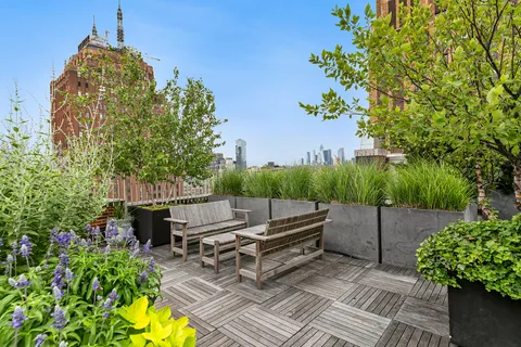 a backyard of a house with lots of green space and outdoor seating