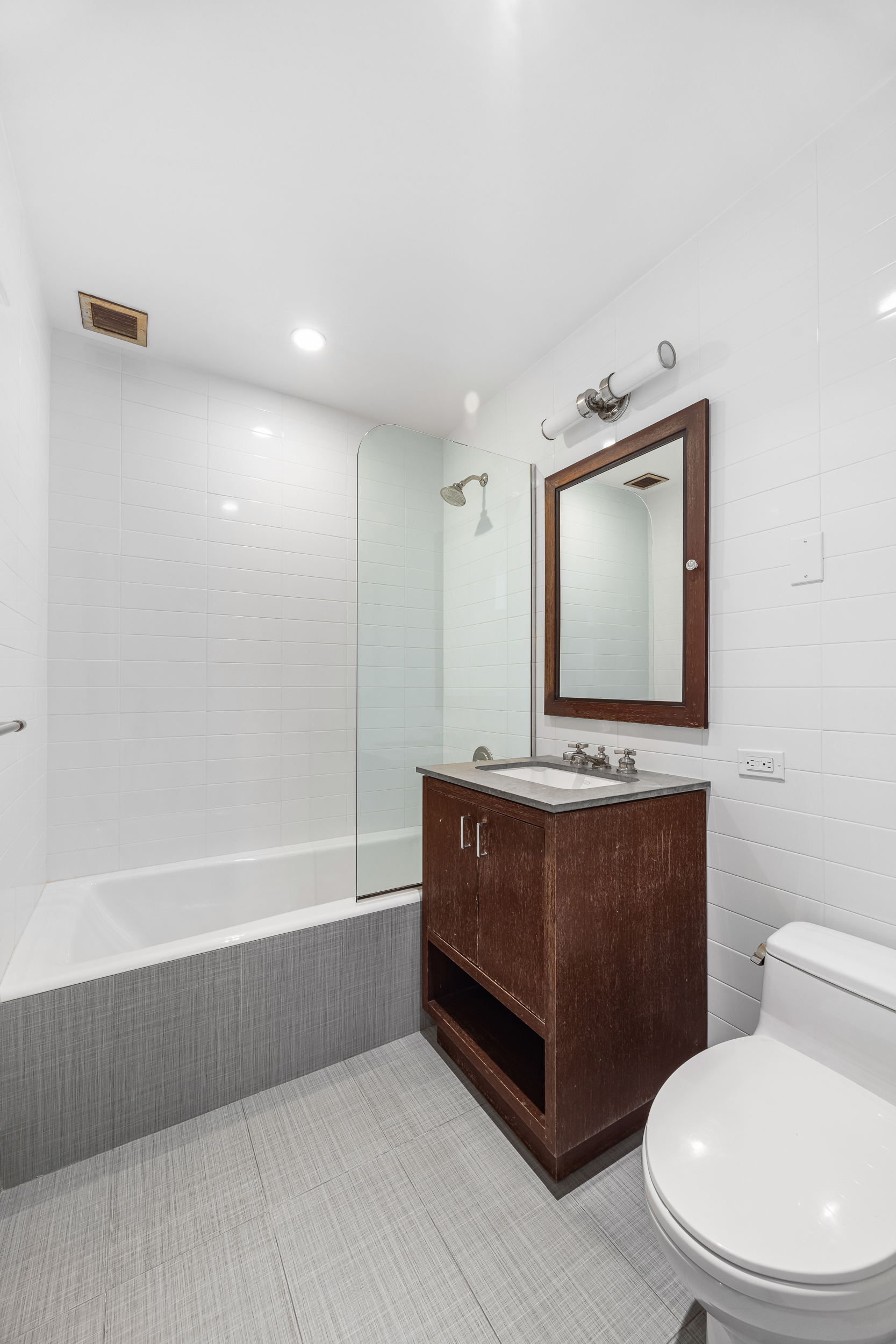 100 Riverside Boulevard, Unit 21A Manhattan, NY 10069 - Photo 9 of 22 a bathroom with a toilet sink and mirror