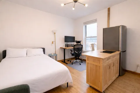 a bedroom with a bed and a flat screen tv