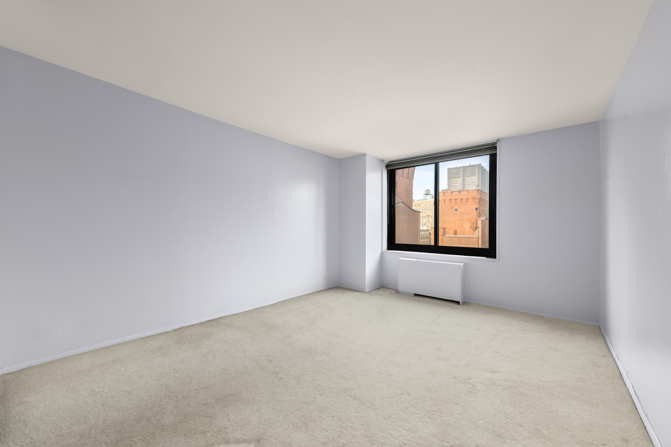 40 East 94th Street, Unit 6F Manhattan, NY 10128 - Photo 5 of 17 an empty room with windows