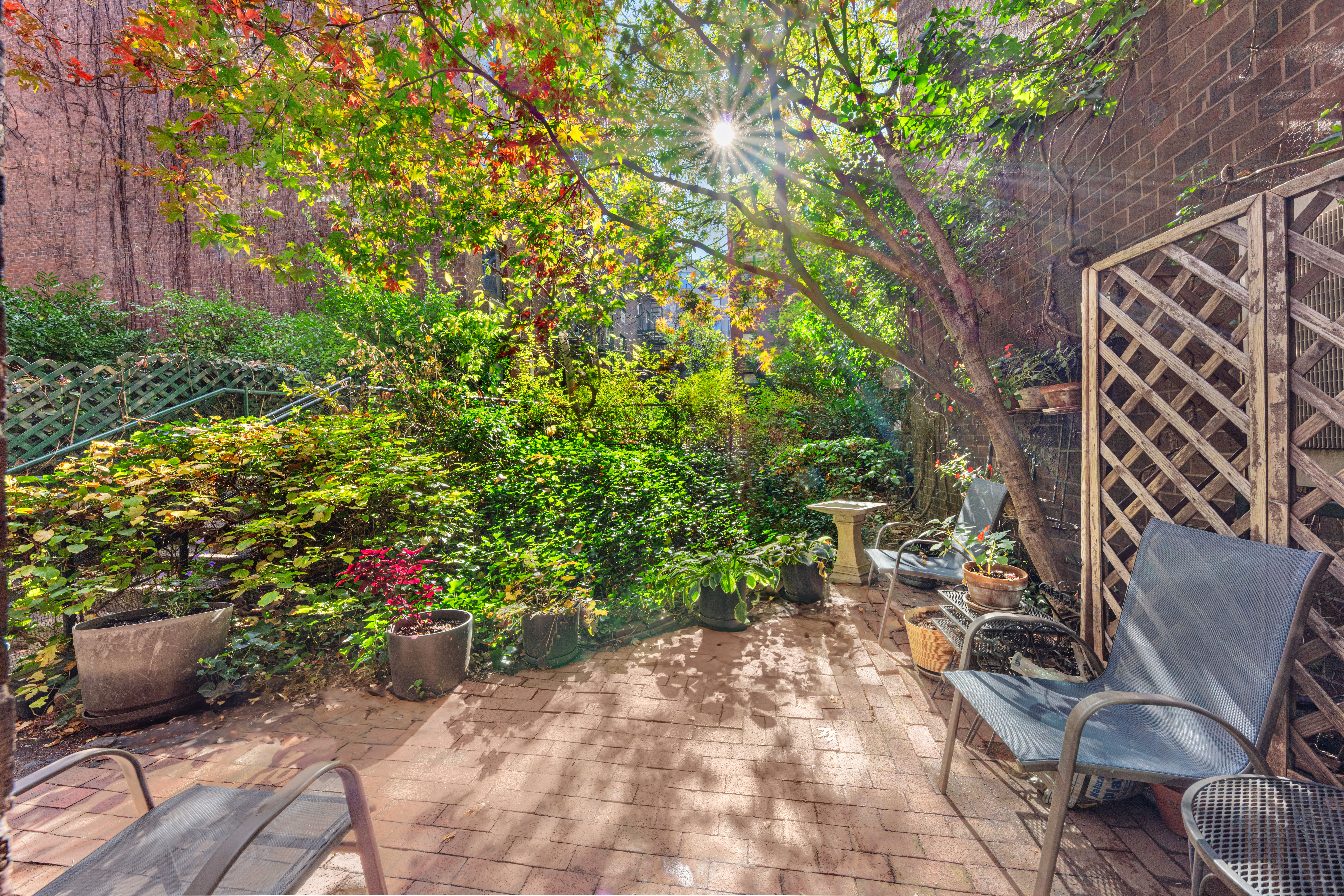129 Barrow Street, Unit GA Manhattan, NY 10014 - Photo 8 of 17 a view of a backyard with potted plants