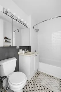 a bathroom with a sink a toilet a shower and a mirror