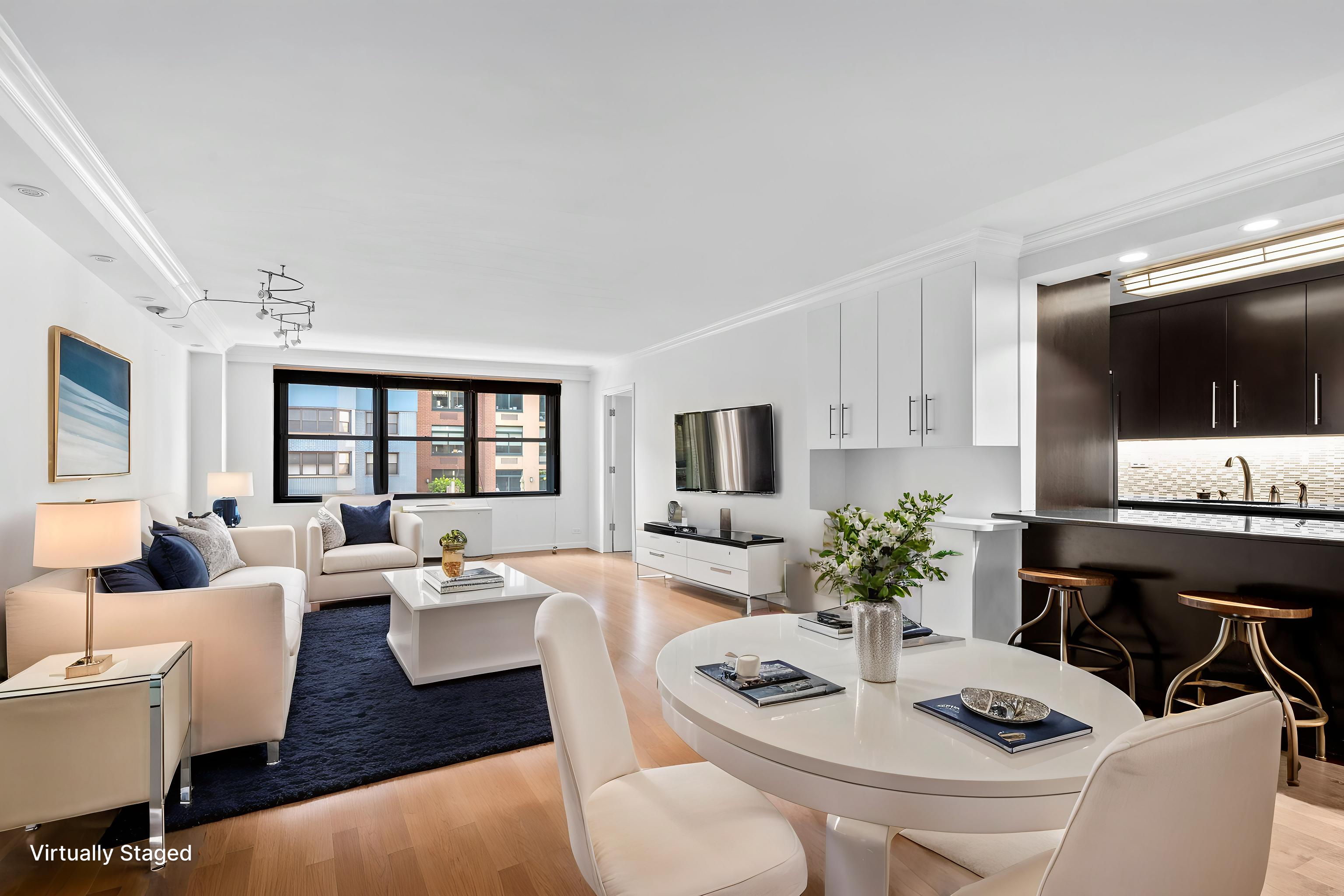 225 East 57th Street, Unit 14F Manhattan, NY 10022 - Photo 3 of 14 a living room with furniture a flat screen tv and a large window