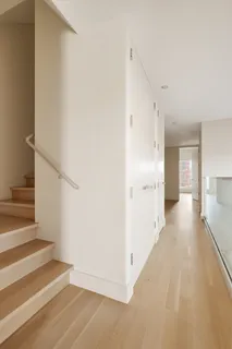 a view of a hallway view with wooden floor and staircase