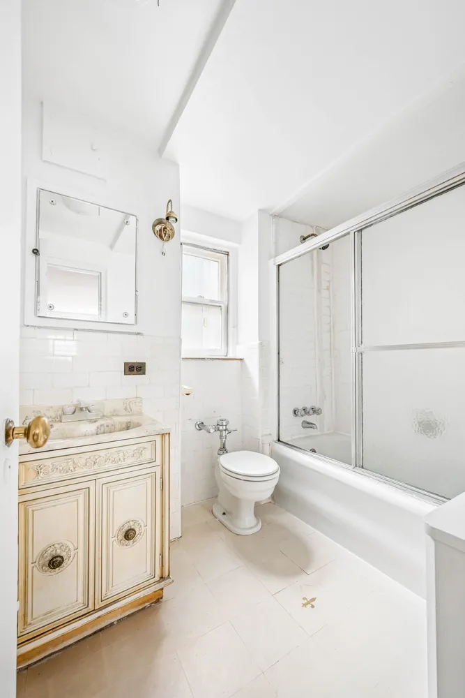 a bathroom with a toilet a sink a vanity and mirror