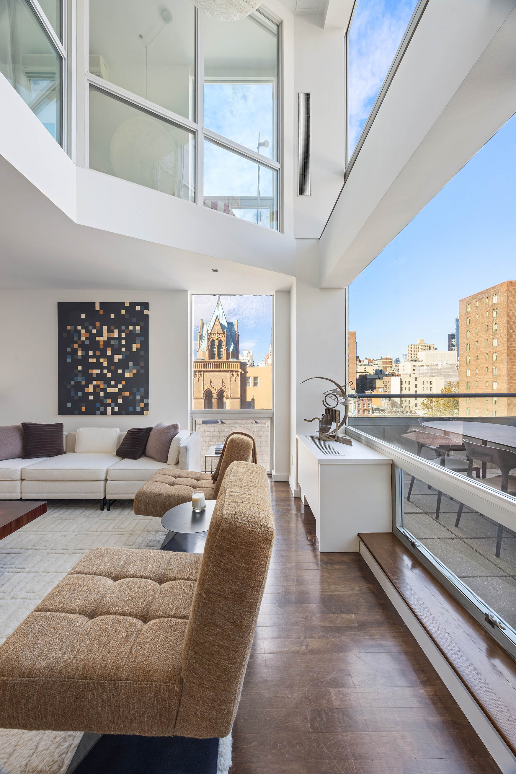 425 East 13th Street, Unit PHFG Manhattan, NY 10009 - Photo 5 of 31 a living room with furniture and a large window