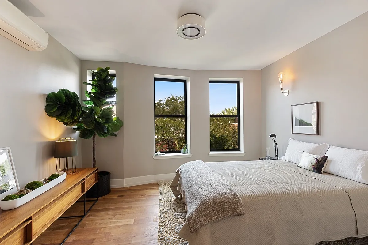 790 St Johns Place, Unit 4A Brooklyn, NY 11216 - Photo 3 of 8 a bedroom with a bed and a potted plant