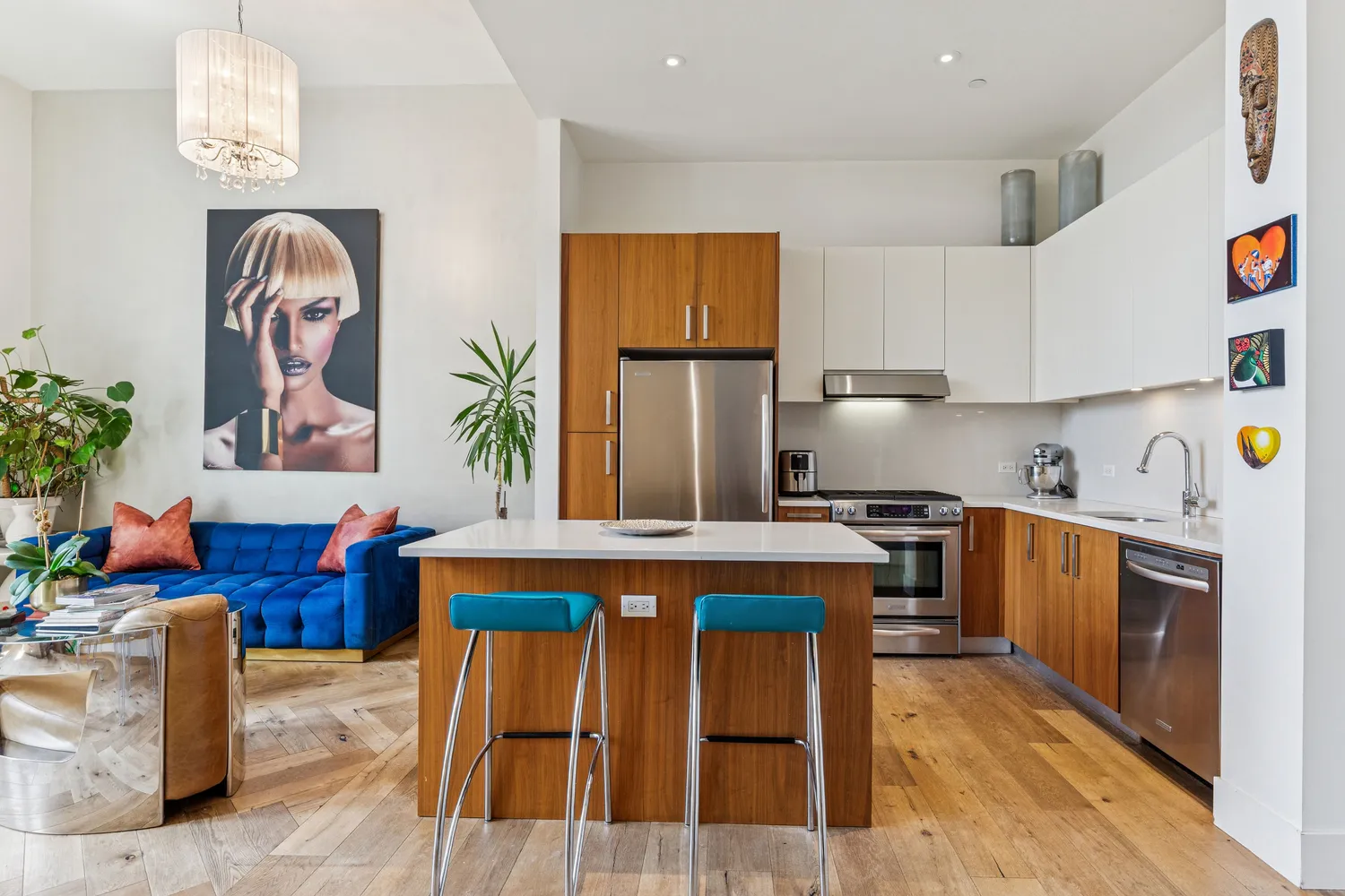 a kitchen with stainless steel appliances granite countertop a stove a sink dishwasher and cabinets with wooden floor