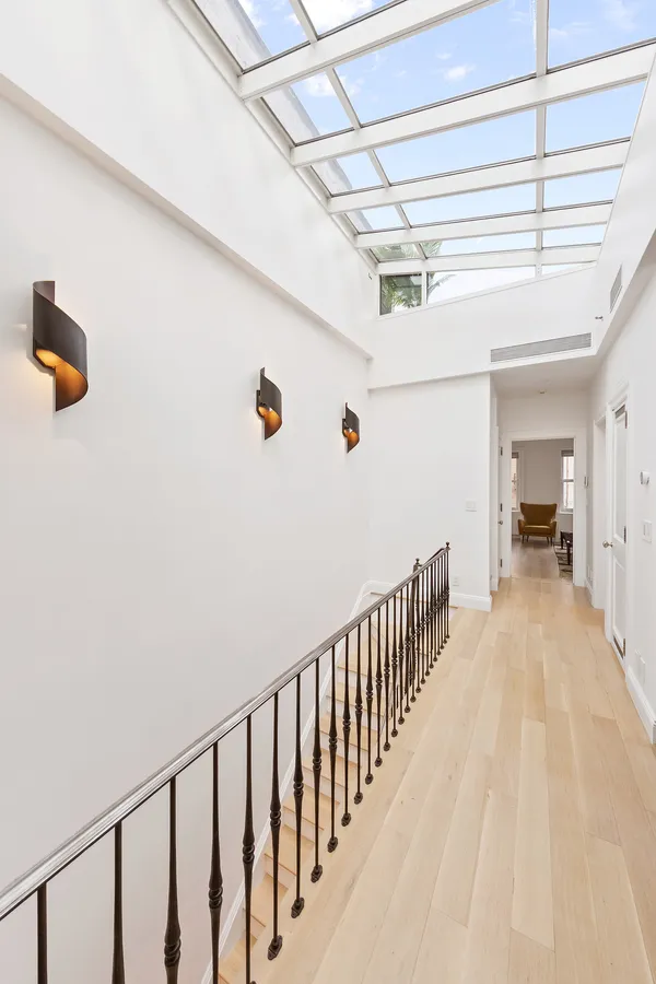 a view of hallway with wooden floor