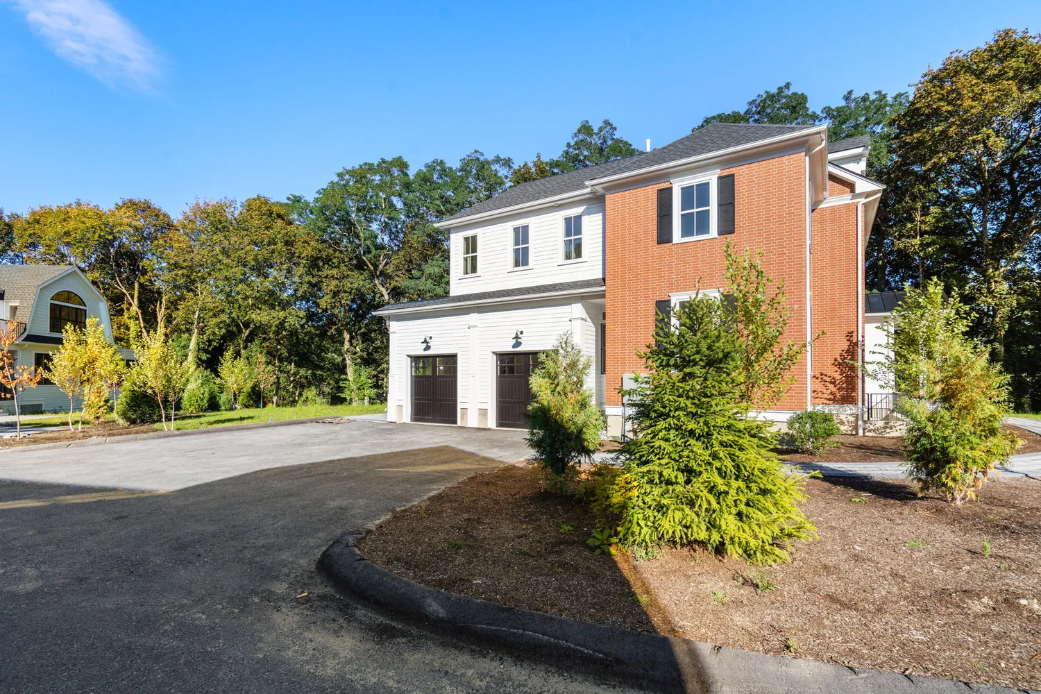 a front view of a house with a yard and a garage