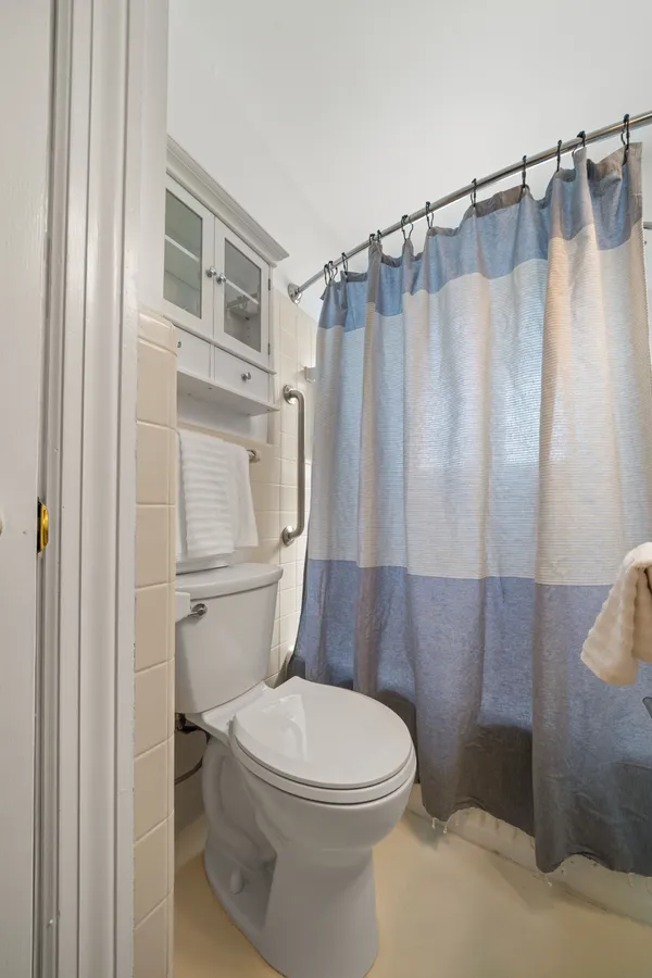 a white toilet sitting next to a bathroom sink